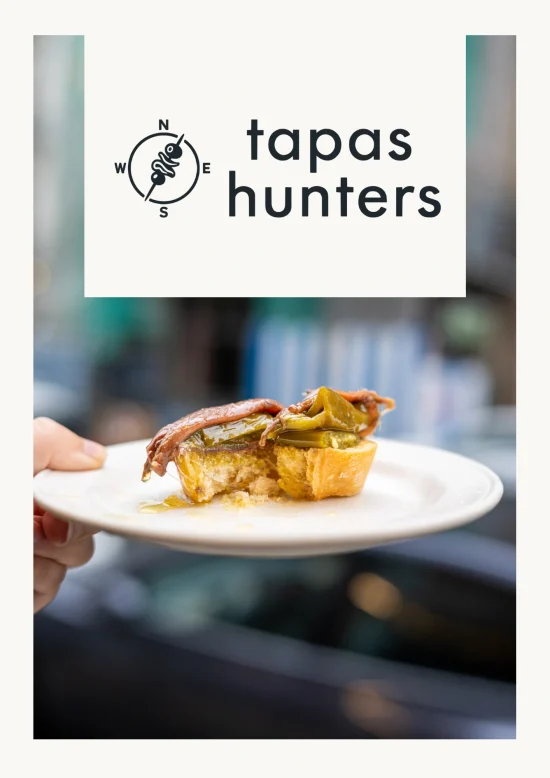 Tapas Hunters Issue 02 cover — logo over a pintxo de antxoa with anchovy and green pepper on an oil-soaked baguette at Antonio Bar, San Sebastián