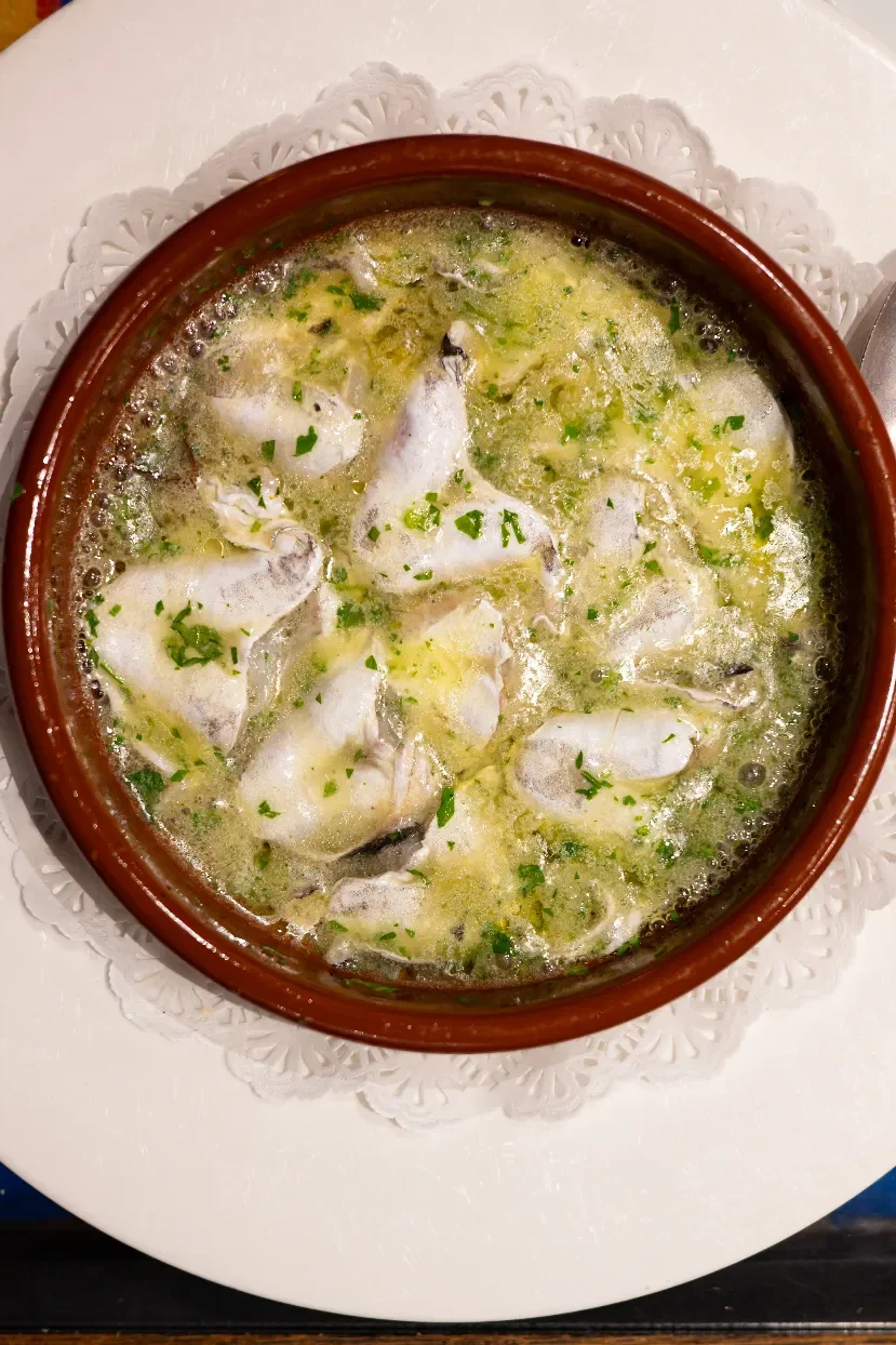 Kokotxas de merluza — hake cheeks in a bubbling green garlic and parsley sauce in a clay cazuela at La Cepa de Bernardo, San Sebastián