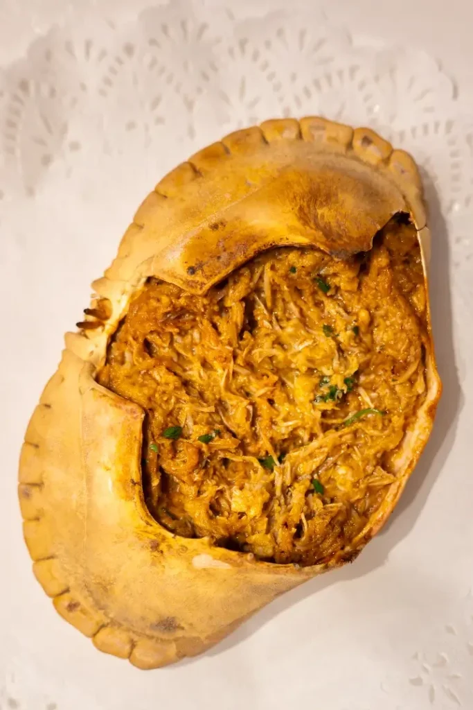 Txangurro al horno — baked spider crab meat in a golden roasted shell with parsley, on a lace doily at La Cepa de Bernardo, San Sebastián