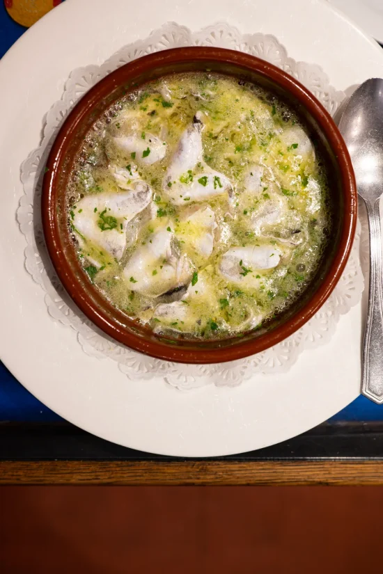 Kokotxas de merluza — hake cheeks in a bubbling green garlic and parsley sauce in a clay cazuela at La Cepa de Bernardo, San Sebastián