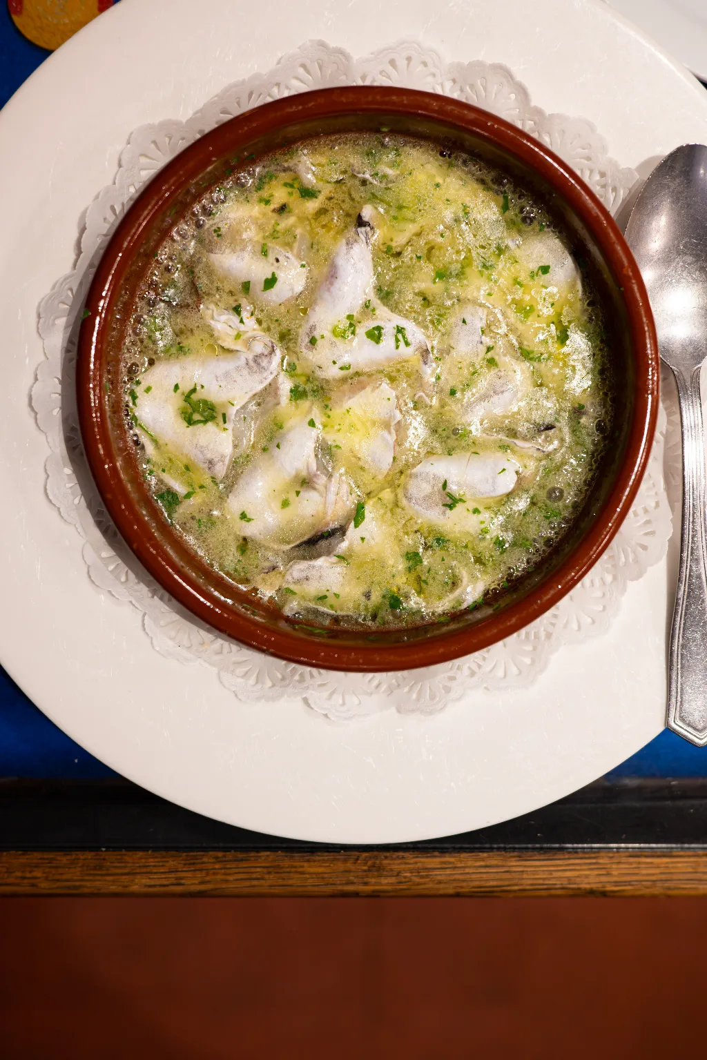 Kokotxas de merluza — hake cheeks in a bubbling green garlic and parsley sauce in a clay cazuela at La Cepa de Bernardo, San Sebastián