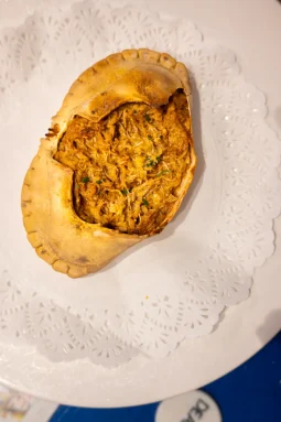 Txangurro al horno — baked spider crab meat in a golden roasted shell with parsley, on a lace doily at La Cepa de Bernardo, San Sebastián