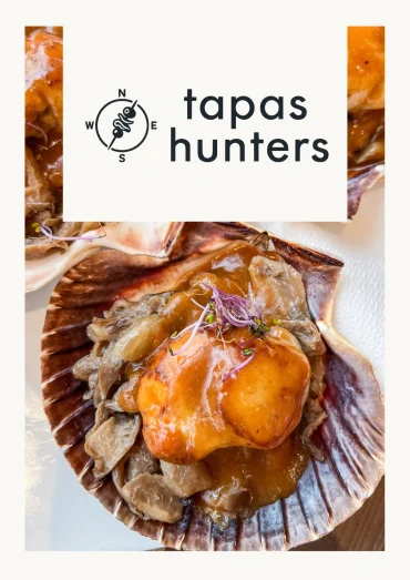 The Tapas Hunters magazine cover featuring a scallop shell dish topped with mushrooms and sauce, Santiago de Compostela.