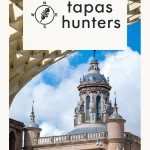 Architectural view of Seville showcasing historic tiled domes framed by the modern wooden structure of the Setas de Sevilla for Tapas Hunters Issue 06.