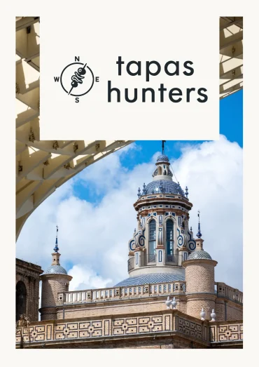 Architectural view of Seville showcasing historic tiled domes framed by the modern wooden structure of the Setas de Sevilla for Tapas Hunters Issue 06.