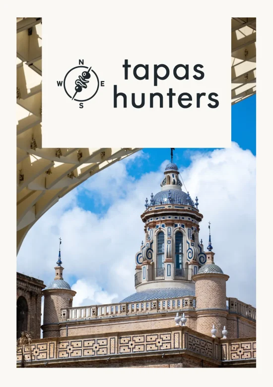 Architectural view of Seville showcasing historic tiled domes framed by the modern wooden structure of the Setas de Sevilla for Tapas Hunters Issue 06.